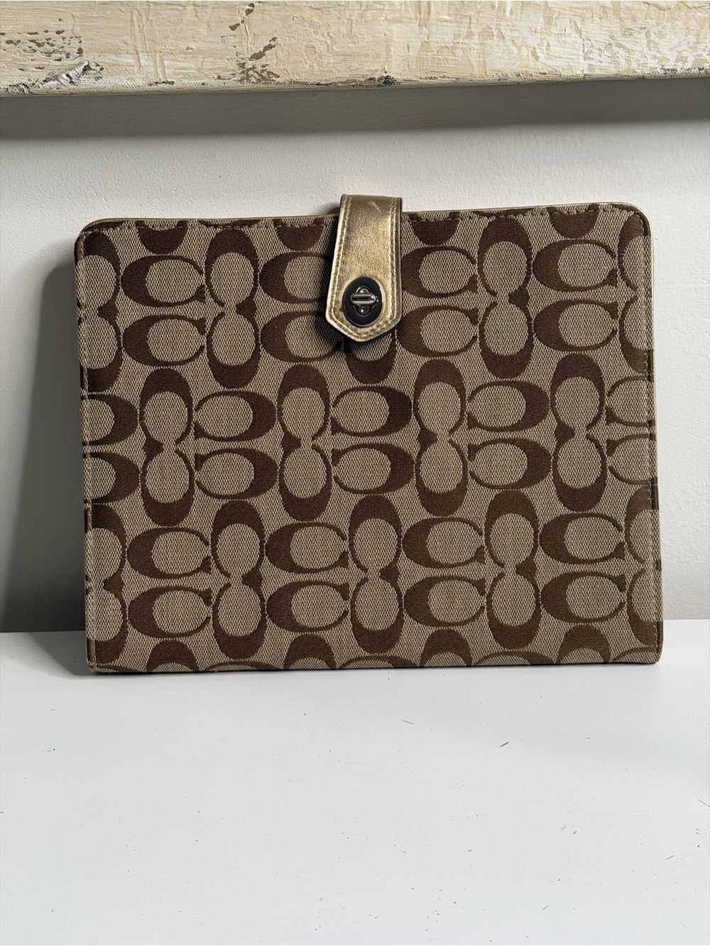 Coach: iPad case/stand featuring the brand's signature print and a pink